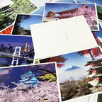Collection of postcards with scenic views of Japan, including cherry blossoms and Mount Fuji.