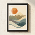 Framed artwork of a mountain and sun illustration on a textured wall.