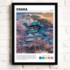 Framed artwork of a Japanese temple with cherry blossoms against a white brick wall.