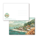 Scenic illustration of a lakeside village with mountains in the background, featuring a matching envelope.