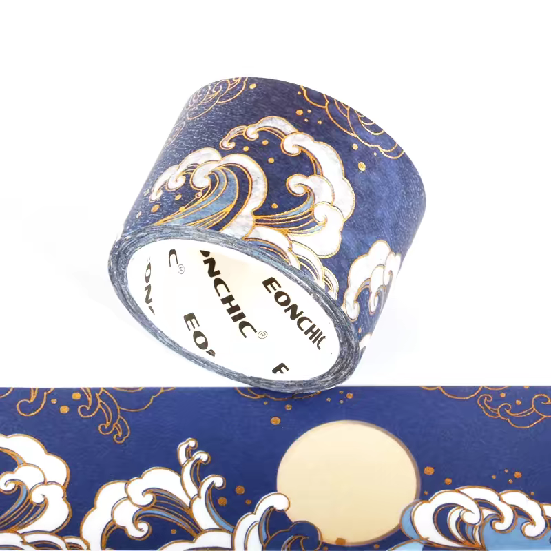 A roll of decorative washi tape with a navy blue background and a wave pattern in cream, white, and light blue, outlined with gold foil details. The brand name 'EOCHIC' is visible on the inner core of the roll.