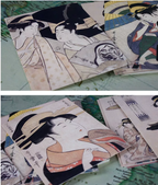 Collection of Japanese woodblock prints on a textured surface