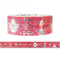 A roll of decorative washi tape with a pink background and a repeating pattern of white damask motifs, cherubs, bows, and small character illustrations, shown with a strip unrolled below on a white background.