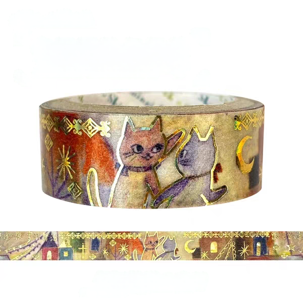A roll of decorative washi tape featuring an illustrated design of two cats on a warm beige background with gold foil accents, shown against a plain white background with a flat strip preview below.