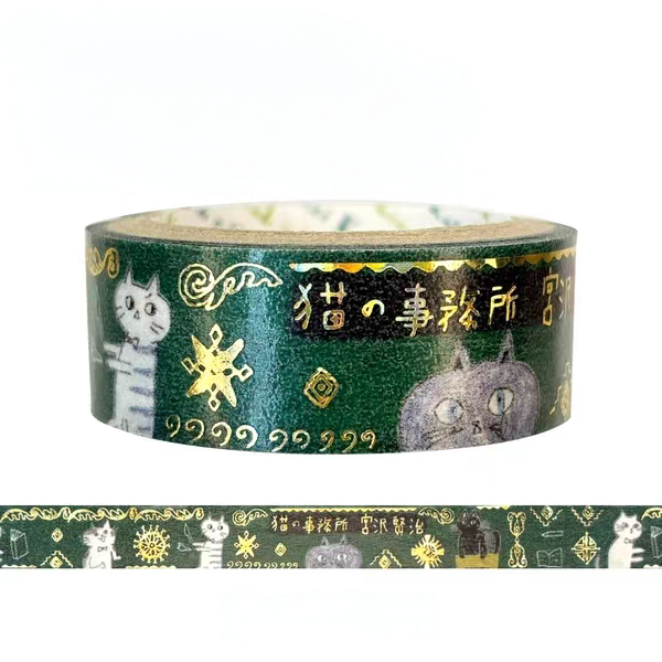 A roll of dark green washi tape with gold foil patterns, featuring illustrations of cats and Japanese text, shown alongside a flat strip of the tape on a white background.