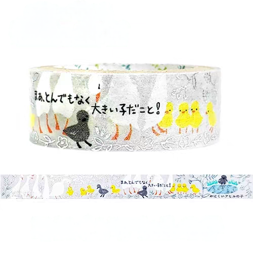 A roll of decorative washi tape featuring a cute Easter-themed illustration with yellow chicks, a black duckling, and Japanese text on a white background. A strip of the tape is shown below the roll to display the full pattern.