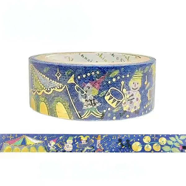 A roll of decorative washi tape with a festive Christmas theme, featuring a blue background with illustrations of Santa Claus, a snowman, a carousel, and gold stars, shown alongside a flat strip of the patterned tape.