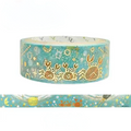 A roll of decorative washi tape with a teal blue background and gold foil crab illustrations, shown with a horizontal strip preview below on a white background.