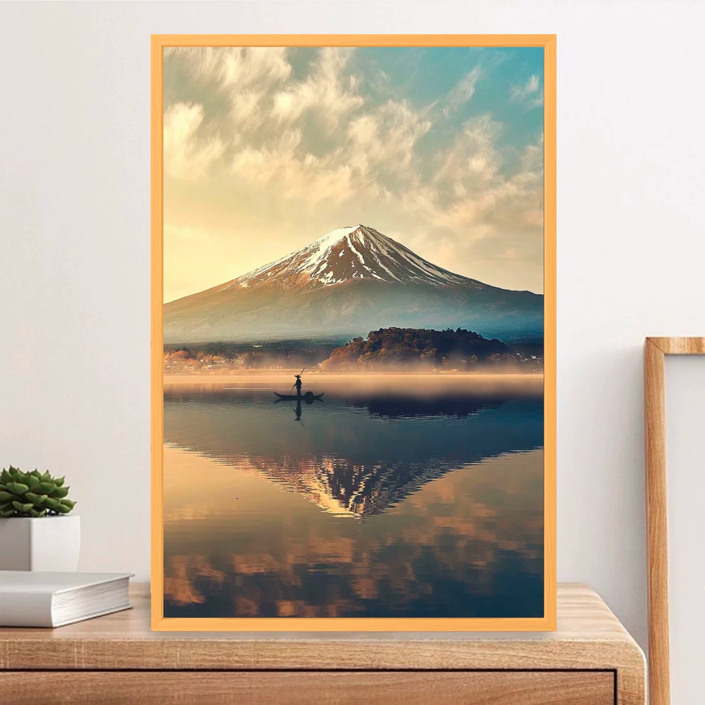 Framed artwork of a mountain landscape with a person in a boat on a lake.