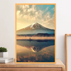 Framed artwork of a mountain landscape with a person in a boat on a lake.