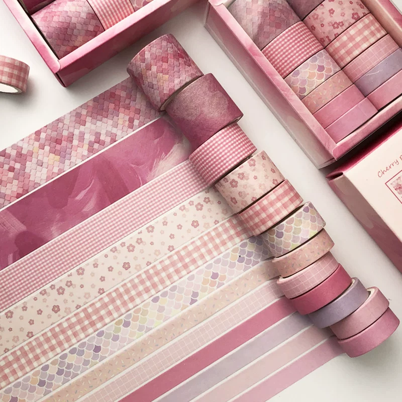 Set of pink washi tape rolls with various patterns on a white background