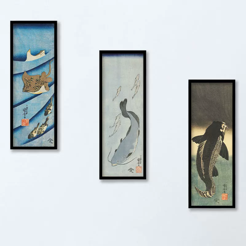 Three framed artworks of fish on a white wall