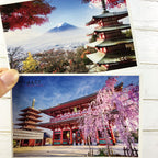 Two postcards showing a pagoda and Mount Fuji, and another with cherry blossoms and a pagoda.