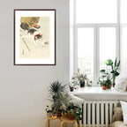 Framed artwork of cats on a wall in a room with plants and a radiator.